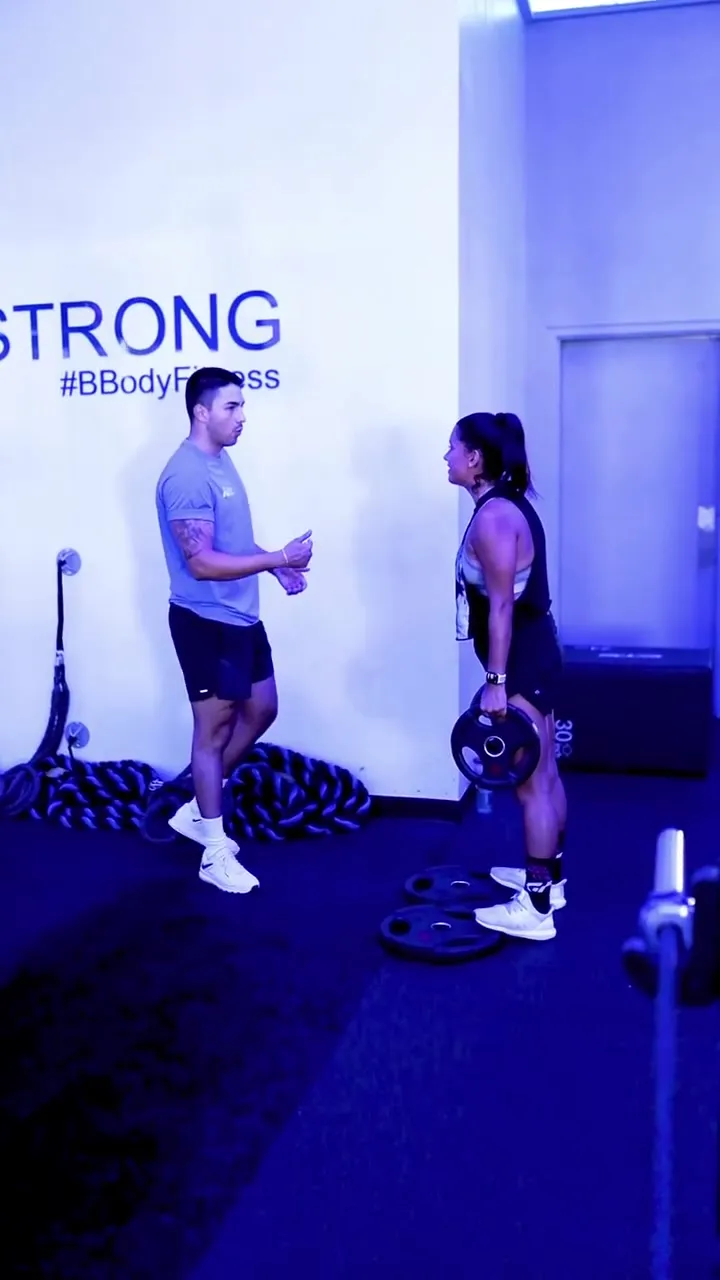 Coach Santi coaching a client one-on-one during a semi-private training session
